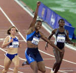 Jones celebrates after passing Ekaterini Thanou (L) and Merlene Ottey (R). REUTERS/David Gray 