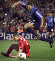 Steven Gerrad tackles Bayer Leverkusen's Lucio