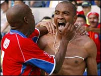 Costa Rica's Mauricio Wright (R) celebrates his goal against China with team mate Hernan Medford.