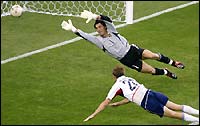 Brian McBride (bottom) heads past Portugal's goalkeeper Vitor Baia for the USA's third goal 