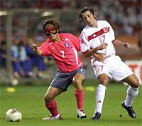 Ilhan Mansiz (R) battles with a Korean defender